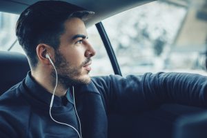 Young man listening music in the car