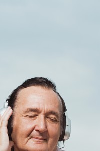 Senior man listening to headphones